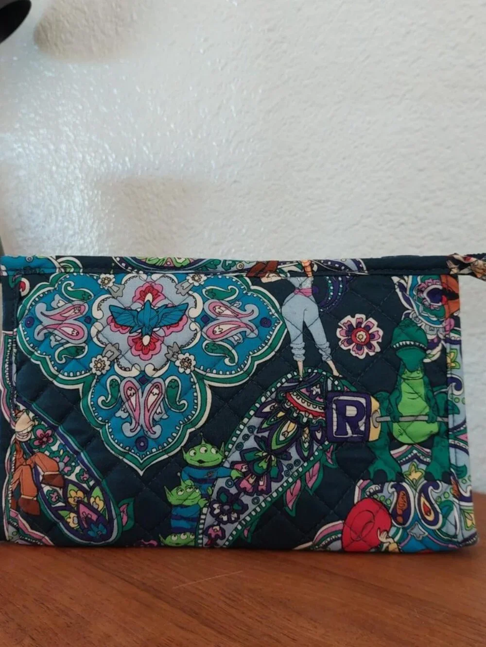 vera bradley Disney Pixar Toy Story quilted pouch with green dinosaur graphic an
